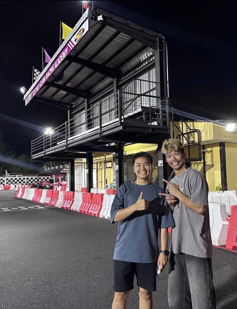 The EEST race-control tower lit up at night with two visitors