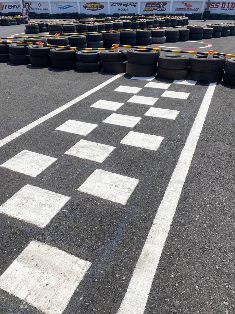 The painted start line and tire-wall barriers on the track