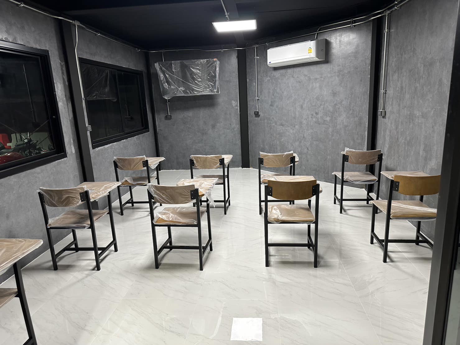 An air-conditioned classroom with chairs set up for theory lessons